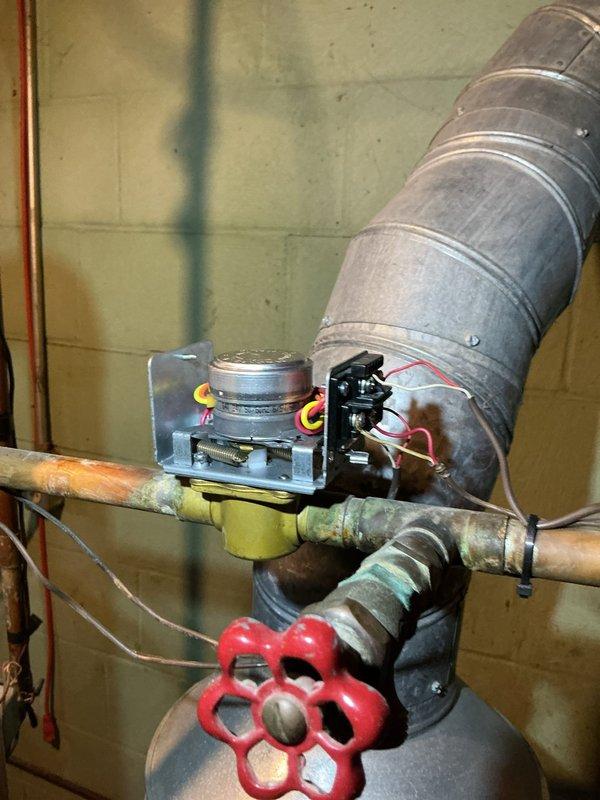 Responded to service call for over 13-year-old boiler system with one zone failing to shut off properly. Upon inspection, identified potential thermostat control issues affecting zone operation. Examined Honeywell control module and associated wiring connections, inspected zone valve with red gate valve handle and electronic sensor assembly, and documented existing copper piping system showing age-related corrosion and patina. Recommended thermostat evaluation and potential replacement to resolve continuous operation issue in affected heating zone.