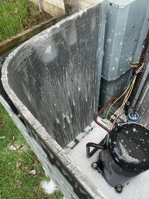 # HVAC Maintenance - Cooling

Performed comprehensive preventive maintenance on residential Amana air conditioning condenser unit. Upon arrival, conducted visual inspection revealing significant dirt and debris accumulation on condenser coil with heavy dark streaking and clogged aluminum fins, which was substantially reducing system efficiency and airflow capacity.

Removed top grille and access panels to gain full access to internal components. Thoroughly cleaned condenser coil using specialized coil cleaner and low-pressure water rinse to remove built-up contamination from aluminum fins. Inspected compressor unit and refrigerant lines, noting white residue on compressor casing and housing panels. Verified all copper refrigerant lines and connections for proper insulation and secure fittings.

Checked electrical connections and wiring harness for signs of wear or corrosion. Confirmed electrical disconnect box operation and proper conduit installation. Reassembled unit with all panels 
