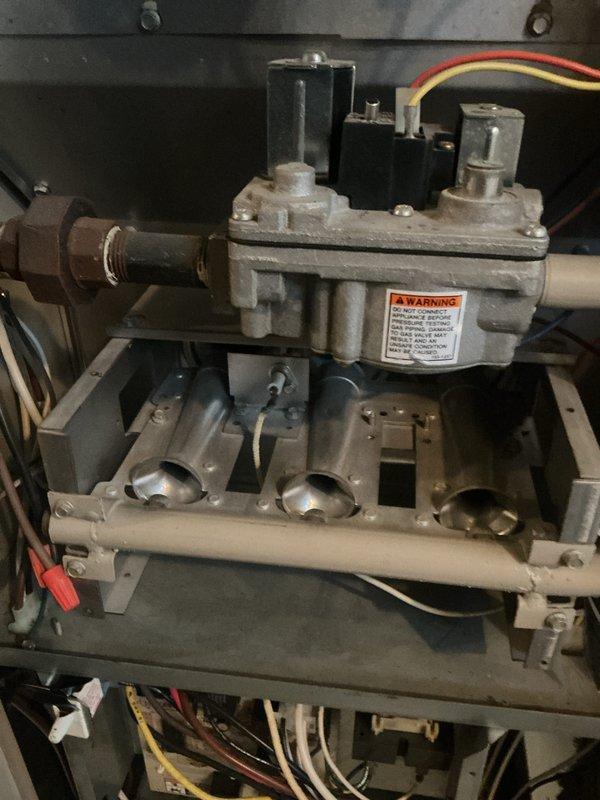Responded to service call for water drainage issue on floor. Upon inspection, identified clogged condensate drain line causing water backup and overflow. Cleared drain line obstruction and verified proper drainage flow. Replaced dirty air filter with new filter per maintenance requirements. Performed system diagnostics including pressure testing to confirm furnace operating within normal parameters. Verified gas valve assembly, ignition components, and burner operation functioning properly. System restored to normal operation with no further water leakage observed.