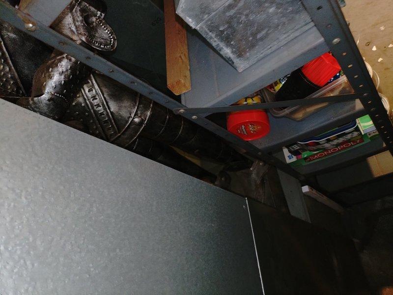 Responded to no heat call for 25-year-old furnace system. Upon arrival, performed diagnostic assessment of aging heating unit located in basement utility area. Documented existing equipment condition and surrounding installation environment, including ductwork and storage configuration. Customer reported complete loss of heating function and had located service provider through online search.