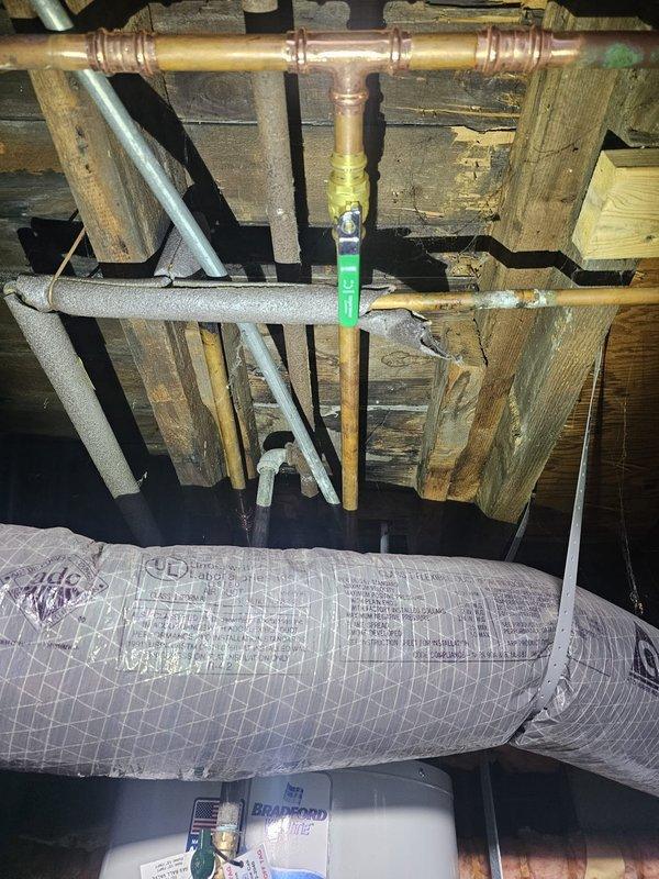 Installed a 30-gallon short natural gas water heater in the crawl space, replacing the existing unit. Upsized the venting system to 4-inch diameter to meet proper exhaust requirements and capped the old venting line. Connected copper supply lines with compression fittings and insulated water lines with foam pipe sleeves to prevent heat loss and condensation. Completed all gas connections in accordance with code specifications and verified proper operation of the new Bradford White unit.