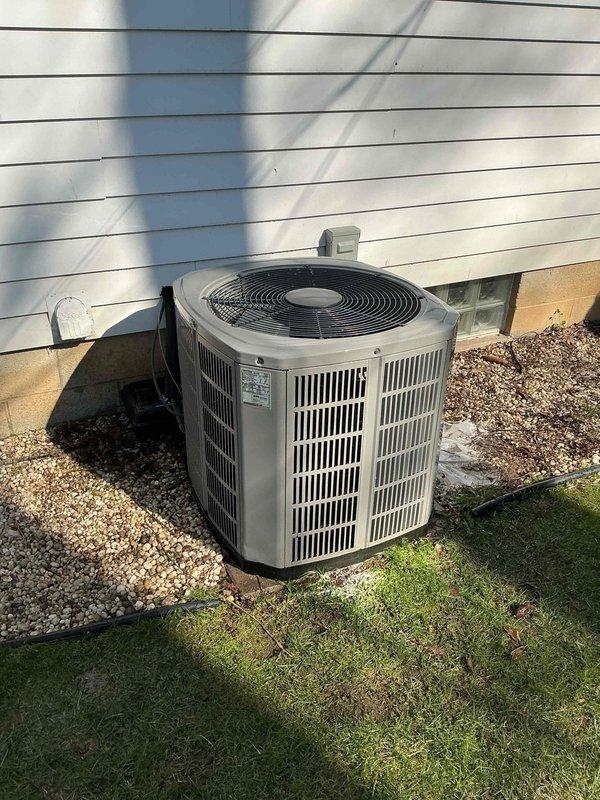 Completed comprehensive tune-up and cleaning service on two HVAC systems: one outdoor air conditioning condenser unit with cylindrical design and top-mounted fan assembly, and one heating system. Performed standard maintenance procedures including inspection of electrical connections and conduit, verification of proper airflow through vertical louver vents, assessment of unit mounting and clearances on concrete and gravel pads, and cleaning of both systems. Both units appeared to be approximately two years old and were found in good operating condition with no major issues identified during the service visit.