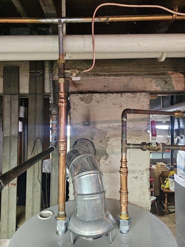 Completed inspection correction work to address multiple code compliance issues. Relocated condenser unit to maintain required 3-foot clearance from gas meter and regulator vent per 2021 International Fuel Gas Code. Sealed flue connections with code-approved materials to ensure proper venting. Re-routed humidifier supply line to hot water side per manufacturer specifications. Shortened T&P discharge tube to meet code requirements. Performed seasonal air conditioning system startup and operational verification.