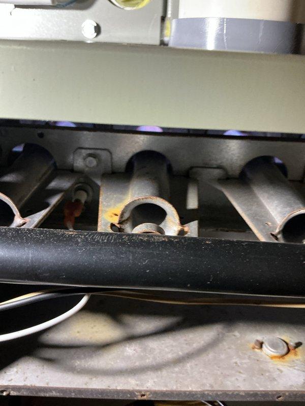 Completed scheduled heating maintenance inspection on residential gas furnace system. Performed thorough visual examination of burner assembly, noting moderate corrosion and rust accumulation on burner ports and manifold, documented condition with photographs for service records. Inspected electrical connections, blower motor assembly, and internal wiring, confirming all components operational and system functioning properly.