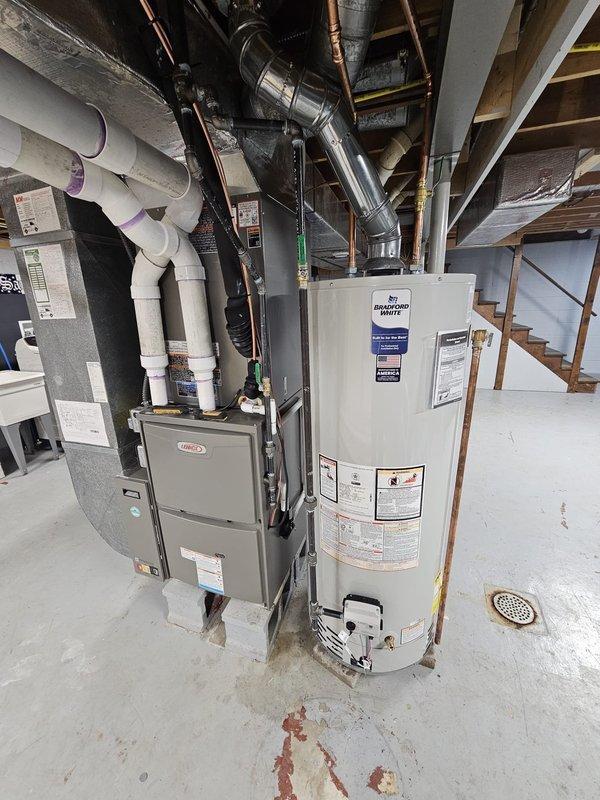 Completed full HVAC system replacement including installation of 96% efficiency 90,000 BTU two-stage variable speed upflow furnace with matching all-aluminum cased evaporator coil. Installed 17 SEER two-stage condensing unit on 36x36 equipment pad with proper refrigerant lineset (7/8" x 50'), electrical disconnect and whip per code requirements. Added 17-gallon whole-home humidifier, 5" media filter rack (20x25x5), and 120V condensate pump to furnace system. Upgraded to E30 7" smart Wi-Fi thermostat for enhanced system control and monitoring. Replaced existing water heater with new 50-gallon Bradford White unit, ensuring proper venting and connections. All equipment installed to manufacturer specifications and local code requirements, with system operations verified and tested for proper function. AHRI reference number 216049281 documented for equipment matching certification.