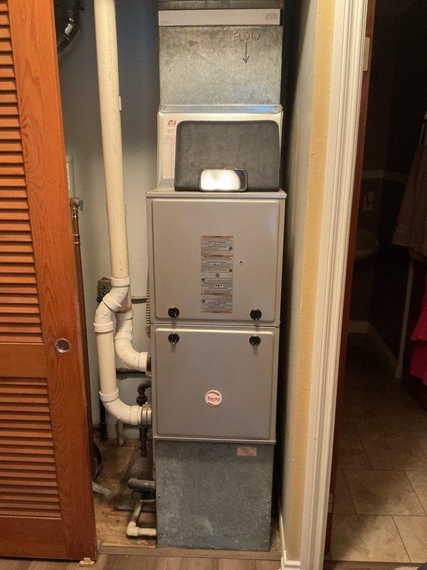Conducted comprehensive evaluation of existing residential HVAC system for replacement estimate. Inspected indoor furnace and air handler assembly located in utility closet, documenting current installation configuration including ductwork, condensate drainage system, and access panel condition. Assessed outdoor condensing unit positioned on concrete pad adjacent to home exterior, noting equipment age, weathering, and electrical disconnect components. Photographed both indoor and outdoor equipment to document existing system specifications, installation layout, and mounting conditions for replacement planning purposes.