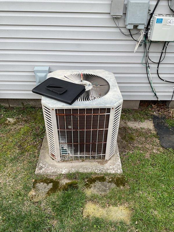 Conducted comprehensive evaluation of existing residential HVAC system for replacement estimate. Inspected indoor furnace and air handler assembly located in utility closet, documenting current installation configuration including ductwork, condensate drainage system, and access panel condition. Assessed outdoor condensing unit positioned on concrete pad adjacent to home exterior, noting equipment age, weathering, and electrical disconnect components. Photographed both indoor and outdoor equipment to document existing system specifications, installation layout, and mounting conditions for replacement planning purposes.