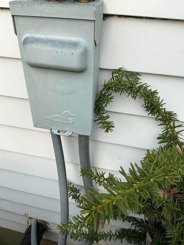 Completed routine cooling maintenance inspection on residential HVAC system. Verified proper operation of outdoor condensing unit, confirmed electrical disconnect box functionality and secure conduit connections, and documented equipment condition with photographs showing all components in serviceable condition with normal wear patterns.