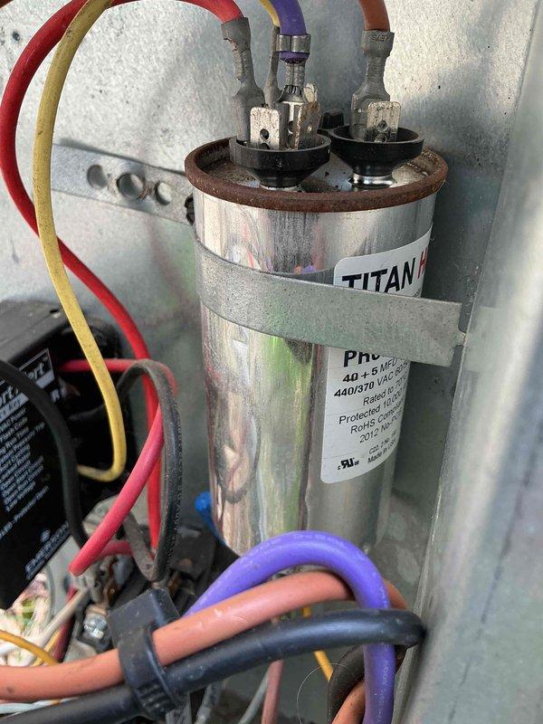 Performed routine maintenance on a 13-year-old residential air conditioning system. Inspected outdoor condenser unit, verified proper operation of dual-run capacitor (40+5 MFD, 440/370V), checked electrical connections and contactor, and confirmed system functionality. Unit operating within normal parameters with no issues identified.