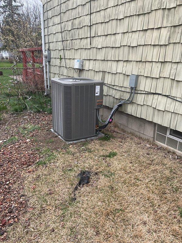 Completed installation of a 2-ton, 14 SEER single-stage air conditioning package system including new cased evaporator coil, condenser unit, refrigerant lineset, concrete equipment pad, electrical disconnect, and whip. Installed metal condensate pump with tubing for proper drainage and mounted new Honeywell T6 programmable thermostat on interior wall for system control. All components tested and verified operational upon completion.