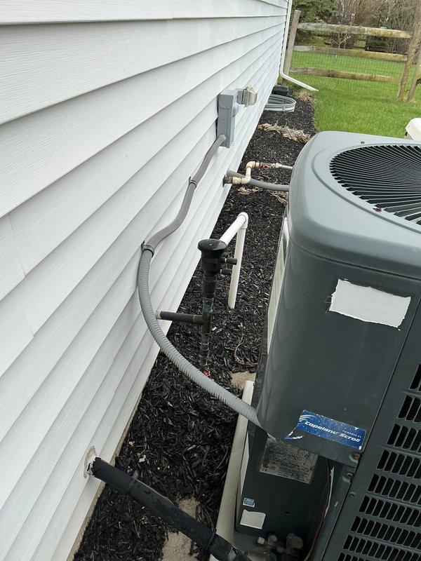 Completed comprehensive preventive maintenance tune-up on residential air conditioning system located on side of home. Unit is 10-20 years old and was thoroughly inspected, cleaned, and tested according to manufacturer specifications. Performed standard maintenance procedures including checking refrigerant levels, inspecting electrical connections, cleaning condenser coils, verifying proper airflow, and ensuring all components are operating within normal parameters for optimal cooling performance.