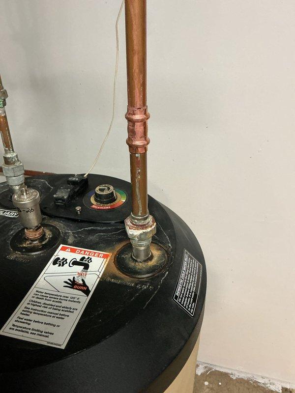 Responded to service call for reported leaking bleeder valve on heating system. Upon inspection, identified the issue was related to the pressure relief valve assembly on the water heater, not the furnace bleeder valve. Examined the temperature and pressure relief valve with sight glass component and associated plumbing connections. Assessed the copper piping, compression fittings, and valve assembly for signs of leakage or failure. Documented equipment condition including natural oxidation on copper lines and overall system configuration for service records.