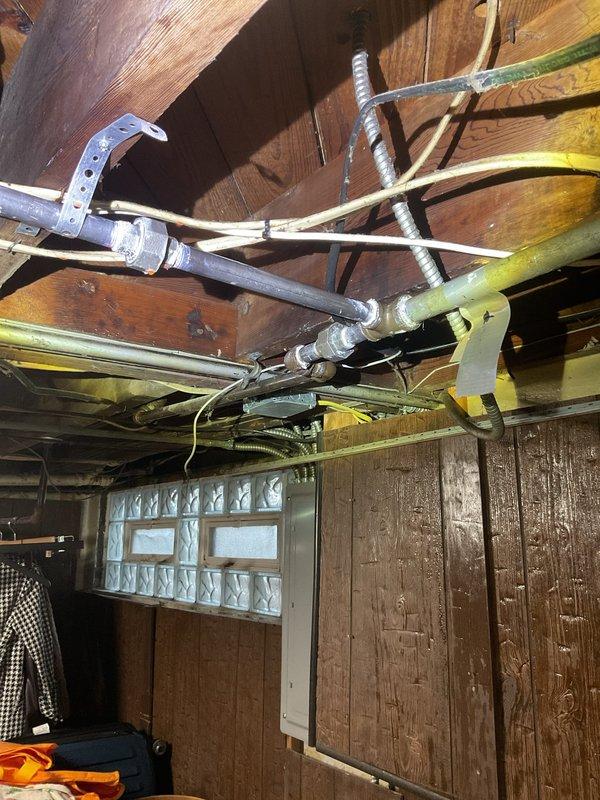 Responded to gas service call where utility company had shut off gas supply due to flagged fittings on furnace and water heater connections. Performed comprehensive pressure test on all gas piping and fittings throughout the system, including lines servicing the heating equipment and water heater in the basement utility area. Inspected multiple connection points that had been previously identified as potential leak sources, tested all joints and fittings for integrity, and verified system met code requirements for safe operation and gas restoration.