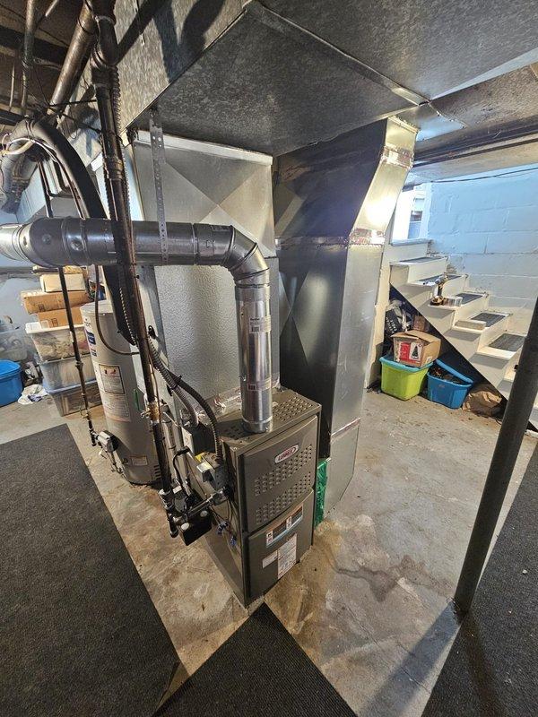 Completed installation of 80% efficiency upflow furnace in basement location, including modification of return air plenum with required metalwork and quarter-turn spin configuration for proper alignment. Installed 6-inch by 35-foot chimney liner for two-story application to ensure proper venting and code compliance. Replaced existing water heater with 40-gallon short model and installed Honeywell T6 Pro programmable thermostat for system control. All ductwork connections secured, system tested for proper operation, and area left clean and functional.