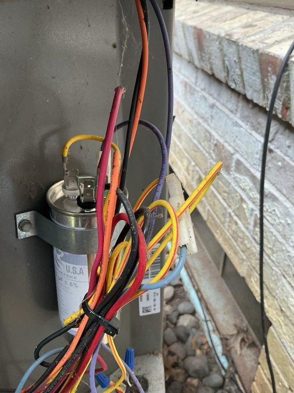 Completed comprehensive maintenance tune-up on 10-year-old air conditioning system located at rear of property. Performed standard preventive maintenance procedures including inspection of outdoor condensing unit, electrical connections, and capacitor assembly. All components inspected and found to be in proper working condition with wiring securely fastened and organized.