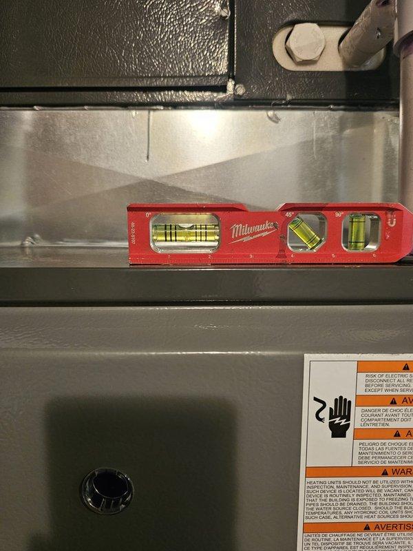 Completed furnace installation with proper leveling and alignment of the new unit. Verified equipment was positioned correctly using precision leveling tools to ensure optimal performance and compliance with manufacturer specifications. Unit secured and labeled with all required safety warnings in place.