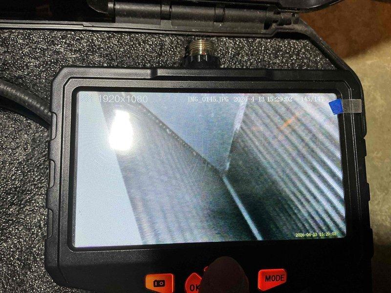 Completed preventive maintenance tune-up on a 5-year-old air conditioning system located in the basement. Performed comprehensive inspection using borescope camera equipment to examine internal ductwork condition and evaporator coil fins, confirming proper cleanliness and structural integrity of all accessible components.