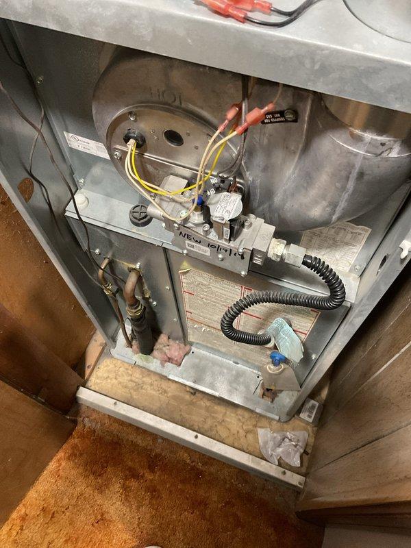 Completed comprehensive estimate for replacement of 2-ton air conditioning system serving mobile home application. Evaluated existing outdoor condensing unit mounted on concrete pad against exterior corrugated metal wall, noting age-related wear and operational degradation. Assessed electrical disconnect box, conduit routing, and power supply configuration. Inspected indoor air handler components including blower motor assembly, gas valve connections, electrical wiring, and cabinet condition to determine compatibility requirements and scope of replacement work necessary for complete system upgrade.