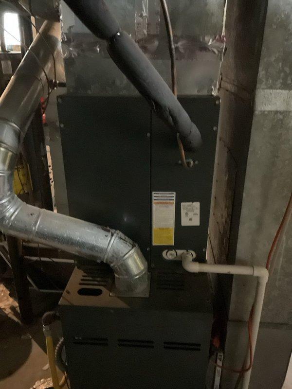 Conducted comprehensive site evaluation for replacement of existing 2.5 ton air conditioning system. Assessed current indoor furnace unit located in basement utility area, noting existing ductwork configuration with multiple supply runs and PVC condensate drainage lines. Evaluated outdoor condenser unit positioned against exterior wall, observing weathered condition and deteriorated performance characteristics. Documented equipment specifications, electrical connections, refrigerant line routing through exterior wall, and clearance requirements for new installation. Provided detailed estimate for complete system replacement including removal of existing equipment and installation of new 2.5 ton air conditioning system.
