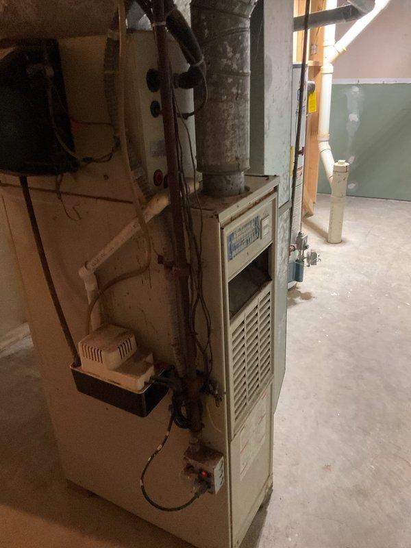Conducted comprehensive assessment of existing HVAC system including outdoor air conditioning condenser unit and basement furnace installation. Evaluated current equipment condition, measured existing unit specifications, documented electrical service configuration including meter assembly and disconnect box, and assessed ductwork infrastructure. Provided detailed replacement estimate for complete furnace and AC system upgrade with equipment sizing recommendations based on home's heating and cooling requirements.