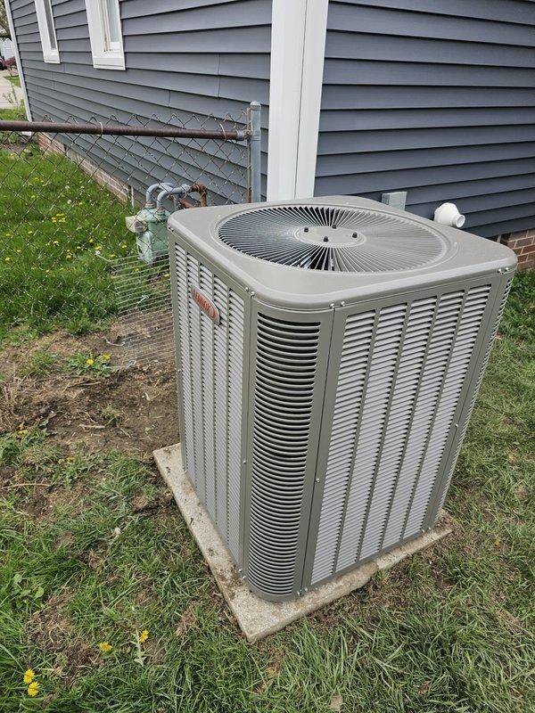 Completed installation of a 2-ton AC package unit with new coil system. Relocated and leveled existing equipment pad to proper position for optimal unit placement. Installed new 3/4-inch copper lineset spanning 15 feet with proper insulation, connecting outdoor condenser to indoor air handler. Ran refrigerant lines along foundation with secure mounting and proper service valve installation. Integrated Honeywell Wi-Fi thermostat for remote temperature control and system monitoring. Indoor installation includes air handler unit positioned adjacent to existing Amana furnace in basement mechanical room, with appropriate electrical conduit and wiring connections. System fully charged, tested for proper operation, and verified all connections for leak-free performance.