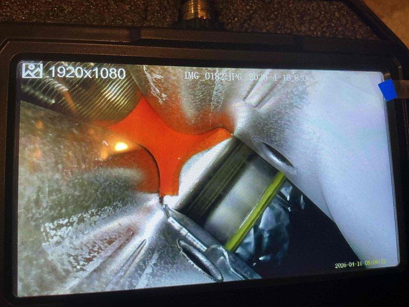 Completed annual air conditioning maintenance on 9-year-old system. Performed visual inspection of evaporator coil using inspection camera, revealing moderate dust and debris accumulation on coil fins. Documented coil condition with photographs showing dirt buildup affecting airflow efficiency. Inspected refrigerant lines and connections, which appear in good condition with proper fittings intact.