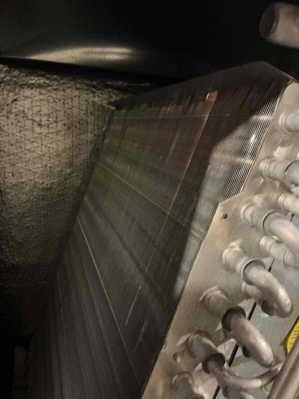 Completed annual air conditioning maintenance on 9-year-old system. Performed visual inspection of evaporator coil using inspection camera, revealing moderate dust and debris accumulation on coil fins. Documented coil condition with photographs showing dirt buildup affecting airflow efficiency. Inspected refrigerant lines and connections, which appear in good condition with proper fittings intact.