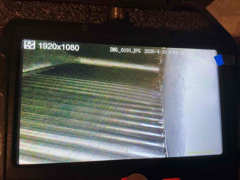 Completed comprehensive AC tune-up on 20-year-old outdoor cooling unit. Performed standard maintenance protocol including inspection of ductwork and flexible connections, verified system operation, and documented equipment condition with interior duct camera inspection showing corrugated transition ductwork and ventilation pathways. Unit operational and ready for cooling season.