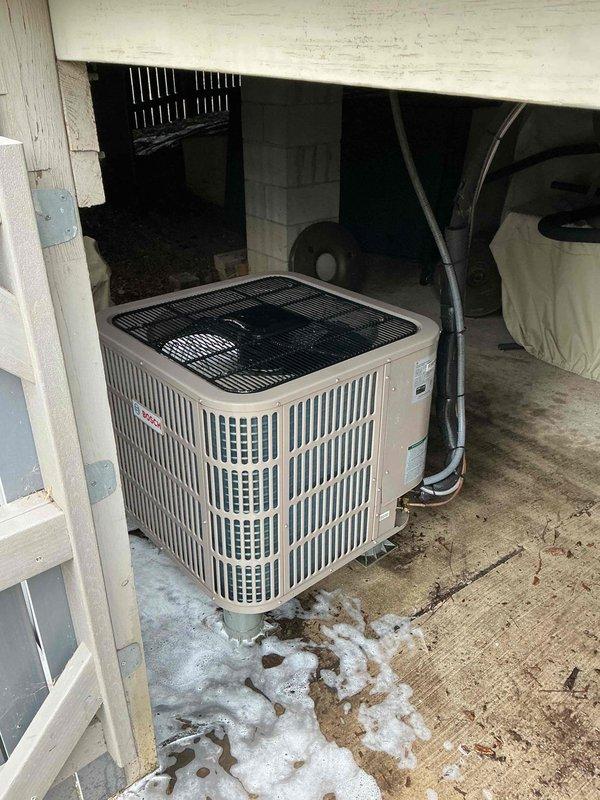 Completed spring maintenance on two cooling systems: a 6-year-old central air conditioning unit and a 15-year-old mini-split system. Upon arrival, performed comprehensive inspection of both units including electrical components, refrigerant lines, and control boards. The central AC unit showed significant refrigerant leak evidenced by white foamy substance accumulation on the concrete pad beneath the condenser. Opened cabinet to access internal components, inspected circuit boards, capacitor, transformer coils, and wiring connections. Checked digital display functionality and verified all electrical connections were secure. Examined copper refrigerant lines and service ports for additional leak points. Assessed blower motor assembly and ventilation system. Documented unit condition with photos showing internal PCB configuration, color-coded wiring, and the refrigerant leak issue requiring immediate attention. The mini-split system was also inspected as part of the scheduled maintenance