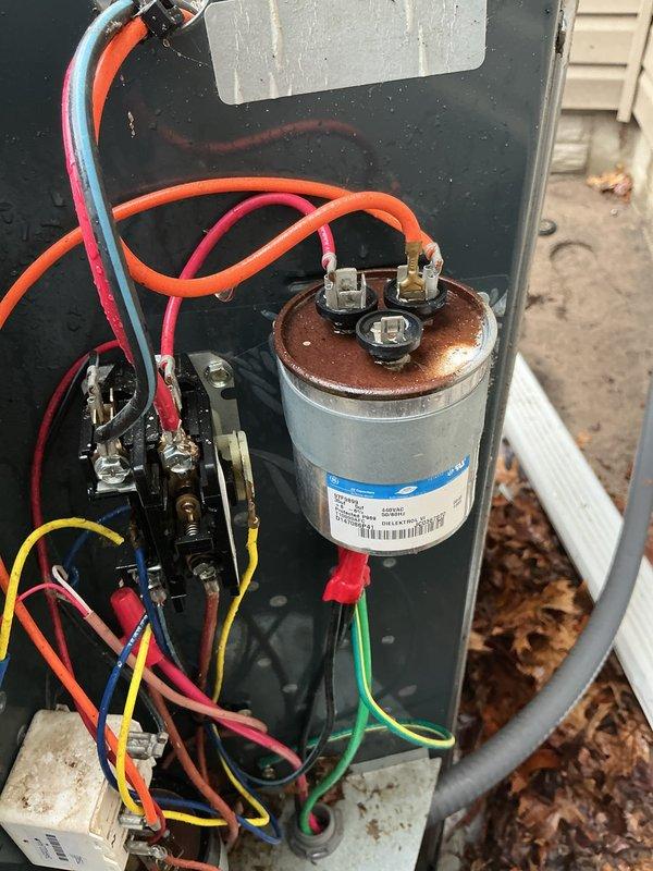 Completed spring maintenance on 16-year-old air conditioning system. Inspected outdoor unit components including contactor, capacitor with visible rust and corrosion on terminals, and electrical connections. Documented equipment condition showing signs of age and weathering throughout system.