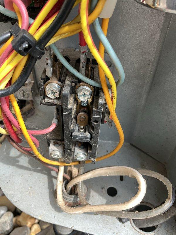 Completed preventive maintenance on 14-year-old Amana air conditioning system during scheduled service window. Performed comprehensive inspection of outdoor condenser unit, noting significant corrosion and deterioration on electrical contactor assembly with visible rust on metal components and terminals. System operational at time of service, though electrical components show age-related wear consistent with unit's service life.