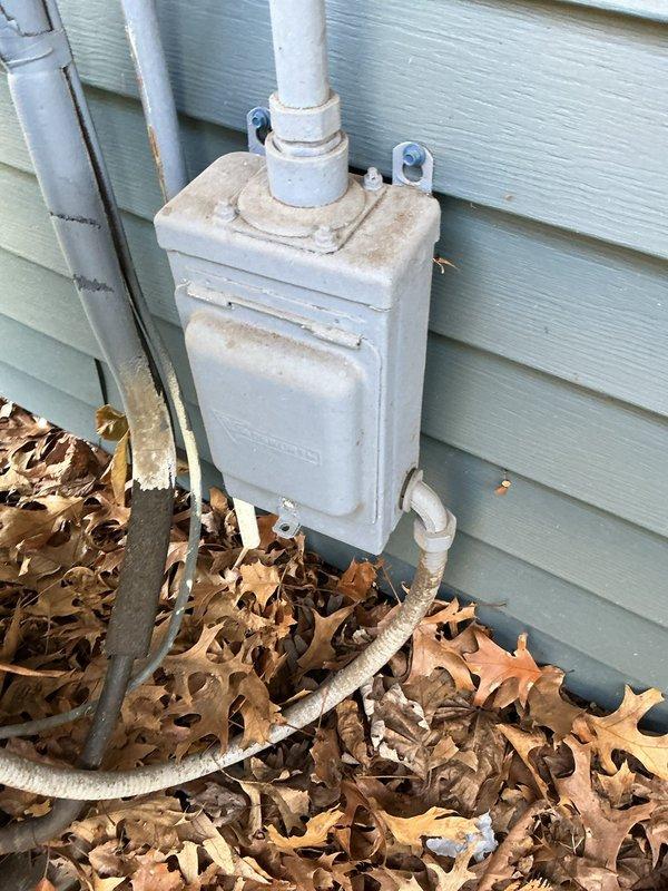 Completed comprehensive preventive maintenance tune-up on 18-year-old residential air conditioning system located at interior entrance. Performed standard diagnostic testing, inspected electrical connections and condenser unit components, and verified proper system operation. Unit showed age-appropriate wear with visible corrosion on fan assembly, but all components functioning within acceptable parameters at time of service.