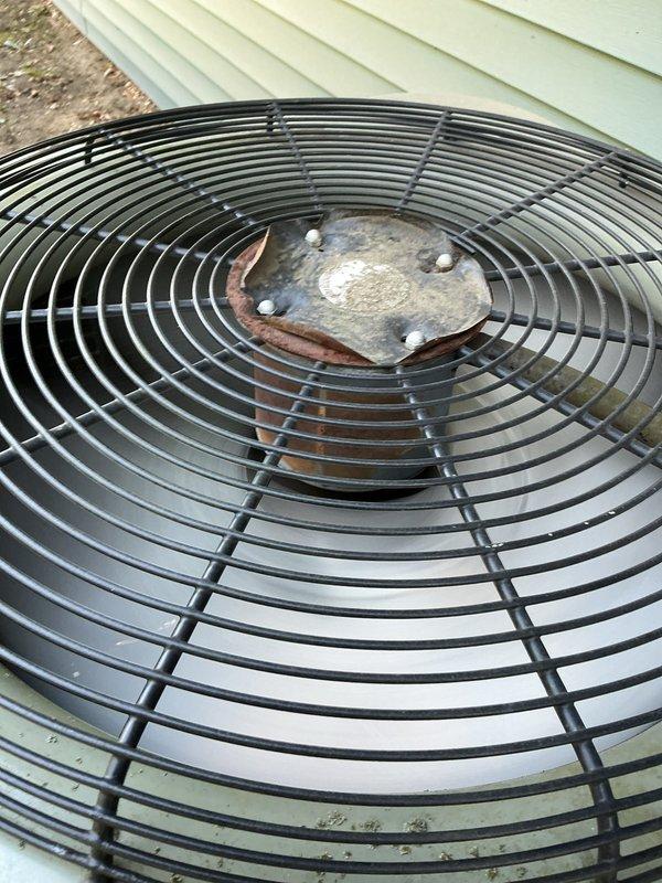 Completed comprehensive preventive maintenance tune-up on 18-year-old residential air conditioning system located at interior entrance. Performed standard diagnostic testing, inspected electrical connections and condenser unit components, and verified proper system operation. Unit showed age-appropriate wear with visible corrosion on fan assembly, but all components functioning within acceptable parameters at time of service.