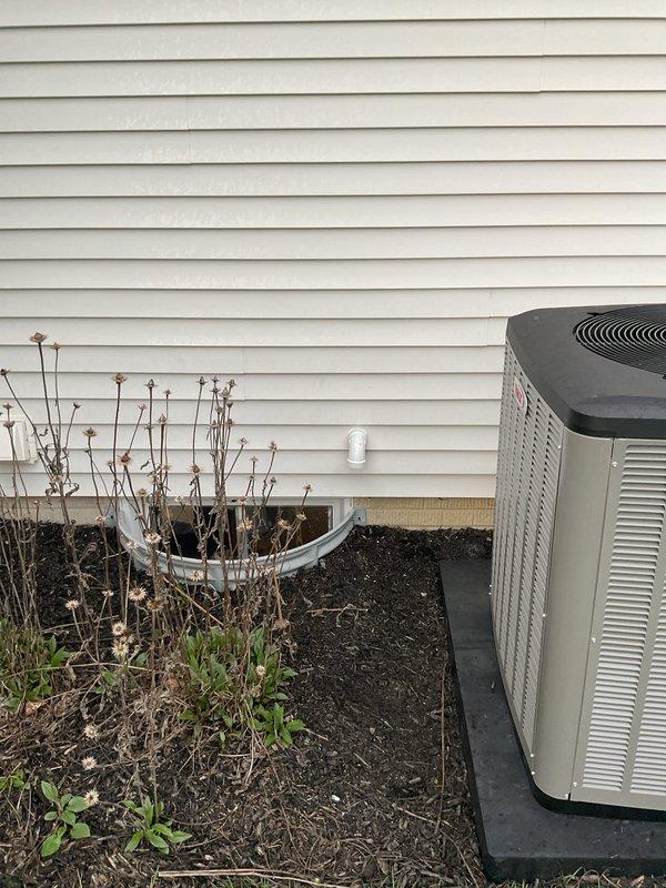 Completed full HVAC system replacement including installation of high-efficiency 20 SEER 4-ton air conditioning unit paired with 97% AFUE 110,000 BTU upflow gas furnace. Installed upflow cased evaporator coil with required metal filter rack sized 20x25x5. Replaced all venting components and ran fresh air intake line for combustion air supply. Installed new 7/8-inch refrigerant line set spanning 50 feet from condenser to air handler. Positioned outdoor condensing unit on new equipment pad placed over existing concrete base. Installed electrical disconnect and whip for outdoor unit power supply. Upgraded to S-40 programmable thermostat for improved system control and efficiency. System achieved AHRI certification match number 215886863, ensuring manufacturer-verified performance ratings. All components tested and verified operational per manufacturer specifications. Unit positioned on residential side yard with proper clearances maintained for service access and airflow requirements.