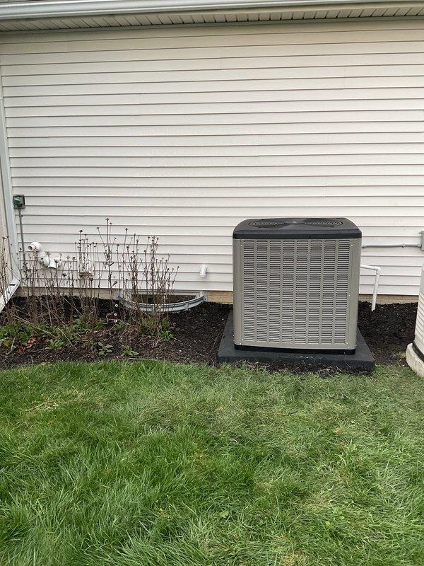 Completed full HVAC system replacement including installation of high-efficiency 20 SEER 4-ton air conditioning unit paired with 97% AFUE 110,000 BTU upflow gas furnace. Installed upflow cased evaporator coil with required metal filter rack sized 20x25x5. Replaced all venting components and ran fresh air intake line for combustion air supply. Installed new 7/8-inch refrigerant line set spanning 50 feet from condenser to air handler. Positioned outdoor condensing unit on new equipment pad placed over existing concrete base. Installed electrical disconnect and whip for outdoor unit power supply. Upgraded to S-40 programmable thermostat for improved system control and efficiency. System achieved AHRI certification match number 215886863, ensuring manufacturer-verified performance ratings. All components tested and verified operational per manufacturer specifications. Unit positioned on residential side yard with proper clearances maintained for service access and airflow requirements.