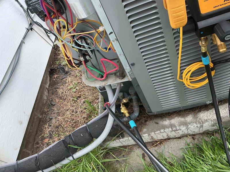 Responded to no-cooling complaint on a 5-year-old air conditioning system at a commercial property. Upon arrival, connected diagnostic equipment to the outdoor condensing unit and performed system evaluation. Found unit non-operational with visible corrosion at base and weathering on exterior components. Tested electrical connections at disconnect box, checked refrigerant pressures at service ports using manifold gauges, and diagnosed system failure preventing compressor operation.
