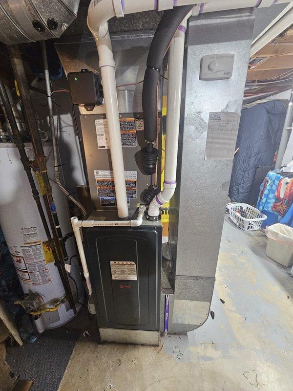 Completed installation of a 14 SEER 2.5 ton air conditioning system with matching upflow cased coil in basement location. Installed new 3/4" x 30' refrigerant lineset connecting outdoor condensing unit to indoor coil, mounted outdoor unit on new 3' equipment pad, and wired system with new disconnect and whip for proper electrical service. Integrated Honeywell Wi-Fi thermostat for remote temperature control and system monitoring. All components tested and verified operational upon completion.