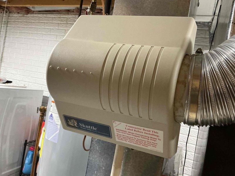 Completed comprehensive HVAC maintenance service including air conditioning system inspection and furnace evaluation. Replaced Skuttle humidifier evaporator pad (part number A04-1725-052) as requested by customer. Inspected control board, wiring connections, and relay components within furnace unit, verified proper humidifier operation with copper supply line connections, and documented equipment condition with photos for service records.