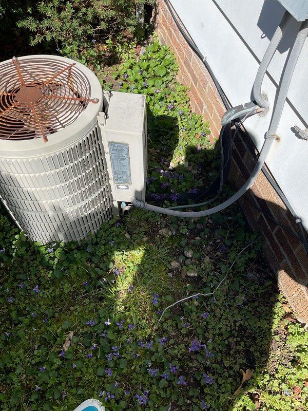 Completed comprehensive estimate for full HVAC system replacement including furnace and air conditioning condenser. The existing outdoor AC unit shows significant weathering and is located in an overgrown area with vegetation encroachment, while the indoor Amana furnace and associated equipment are currently operational but require replacement. Provided detailed assessment and replacement recommendations for both heating and cooling components.