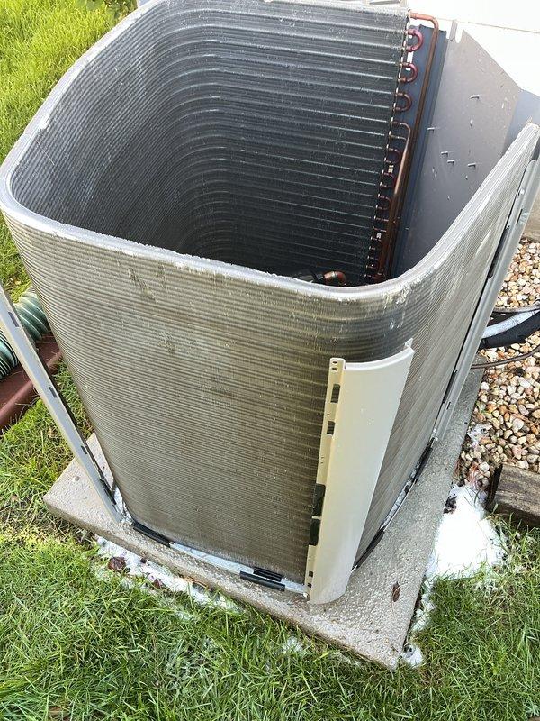 # HVAC Cooling System Maintenance

Performed comprehensive preventive maintenance on a 3-year-old residential air conditioning system. Conducted thorough inspection of outdoor condenser unit, noting weathering and discoloration on exterior casing panels with visible streaking and staining consistent with normal environmental exposure. Examined condenser coil assembly and copper refrigerant lines for proper condition and integrity.

Accessed indoor air handler equipment in basement utility area to complete system evaluation. Inspected electrical connections, wiring, and control components within air handler cabinet. Verified proper operation of condensate drain system, including PVC drain line routing and functionality to prevent water damage and ensure adequate moisture removal.

Cleaned condenser coils to remove accumulated debris and maintain optimal heat transfer efficiency. Checked refrigerant line insulation and connections for signs of wear or damage. Tested system operation thro