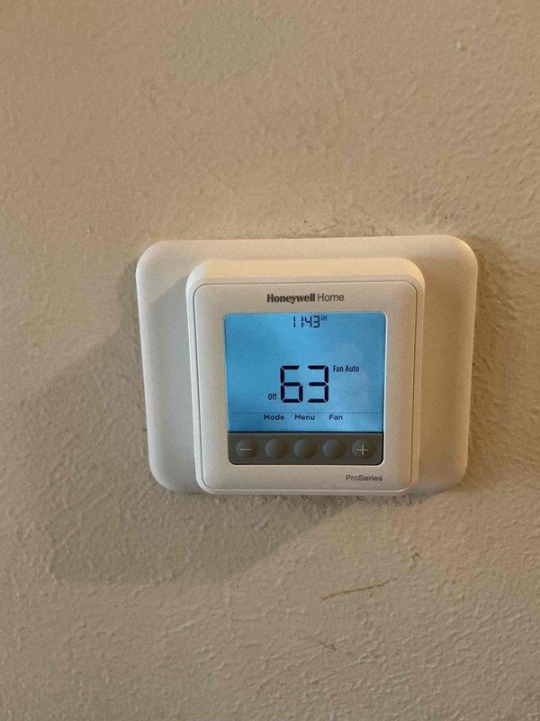 Responded to service call for 20+ year old gas furnace that would not shut off when reaching set temperature. Upon arrival, found multiple thermostats installed in the home, including a Honeywell Home ProSeries digital thermostat and a White-Rodgers thermostat. Diagnosed faulty thermostat control causing continuous furnace operation. Tested thermostat functionality and confirmed improper temperature sensing and relay control preventing proper heating cycle termination at desired setpoint.