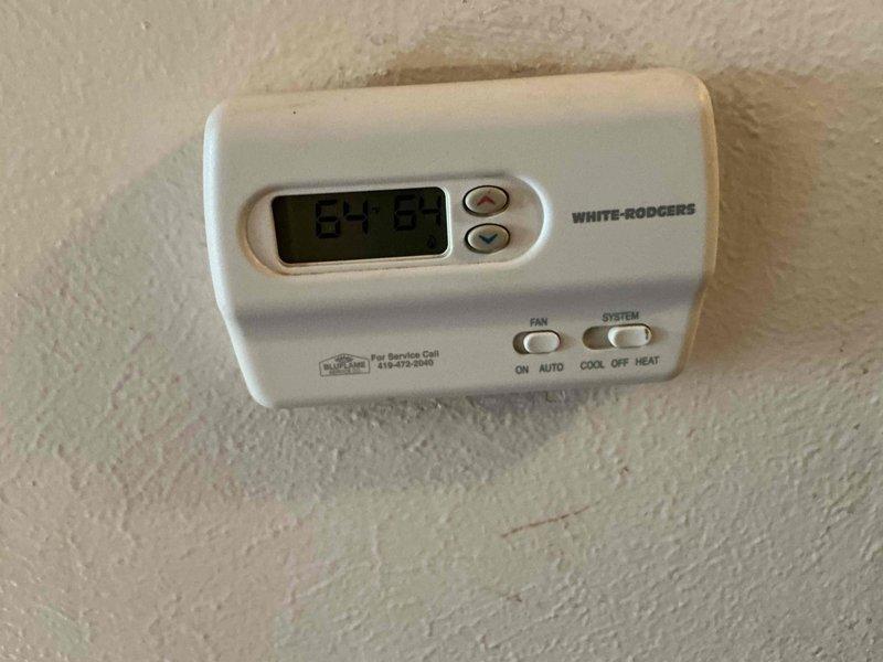 Responded to service call for 20+ year old gas furnace that would not shut off when reaching set temperature. Upon arrival, found multiple thermostats installed in the home, including a Honeywell Home ProSeries digital thermostat and a White-Rodgers thermostat. Diagnosed faulty thermostat control causing continuous furnace operation. Tested thermostat functionality and confirmed improper temperature sensing and relay control preventing proper heating cycle termination at desired setpoint.