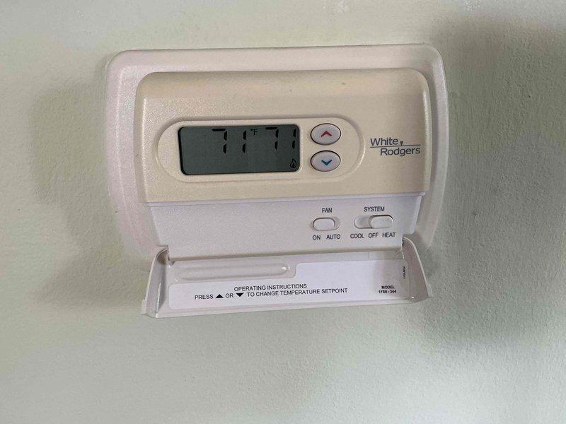 Responded to service call for 17+ year old furnace that would not shut off. Upon arrival, inspected White-Rodgers thermostat and found temperature display reading 77°F with system running continuously. Diagnosed faulty thermostat unable to properly signal heating system to cycle off when setpoint was reached. Adjusted thermostat settings and verified proper temperature control functionality, confirming display reading of 71°F with system responding correctly to temperature changes. System now cycling on and off as designed.