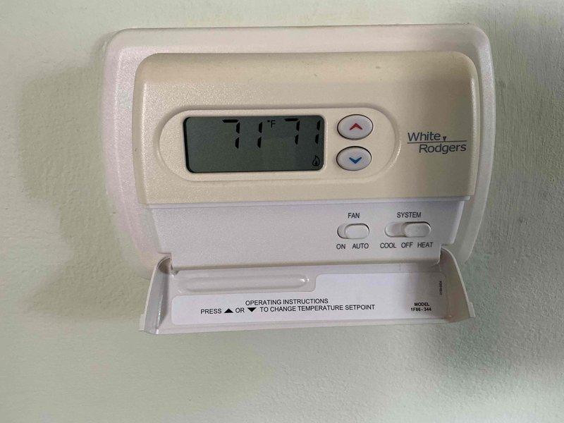 Responded to service call for 17+ year old furnace that would not shut off. Upon arrival, inspected White-Rodgers thermostat and found temperature display reading 77°F with system running continuously. Diagnosed faulty thermostat unable to properly signal heating system to cycle off when setpoint was reached. Adjusted thermostat settings and verified proper temperature control functionality, confirming display reading of 71°F with system responding correctly to temperature changes. System now cycling on and off as designed.