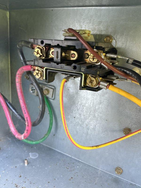 Performed routine cooling maintenance on a 23-year-old air conditioning system. Inspected electrical connections at the terminal block, verified wire integrity and terminal tightness, and examined the condensate drain line with proper mounting hardware. Documented system condition including flexible ductwork and reviewed unit efficiency rating of 96.1 AFUE displayed on the equipment label.