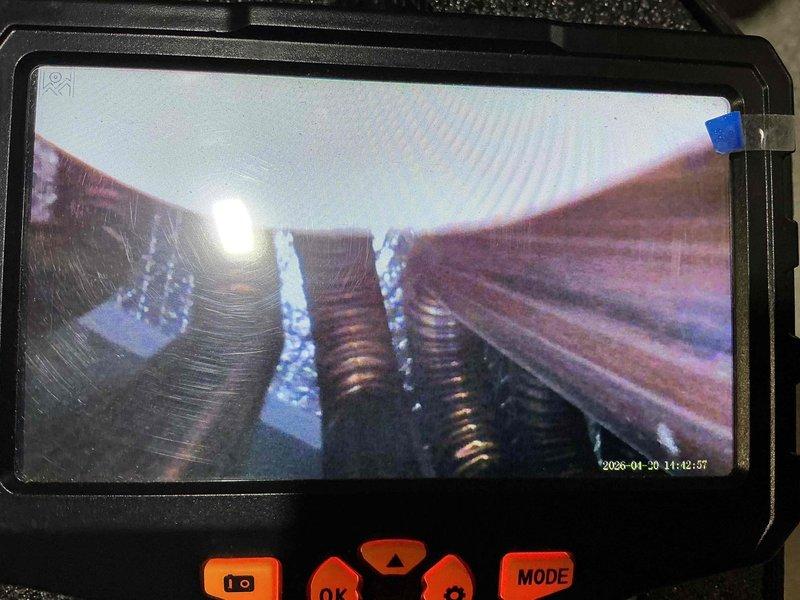 Completed spring maintenance on aging air conditioning system over 25 years old. Performed thorough inspection of heat exchanger coils using borescope camera, revealing mineral deposits and surface oxidation on internal components. System assessed for continued operation with recommendations provided for monitoring performance given age of equipment.