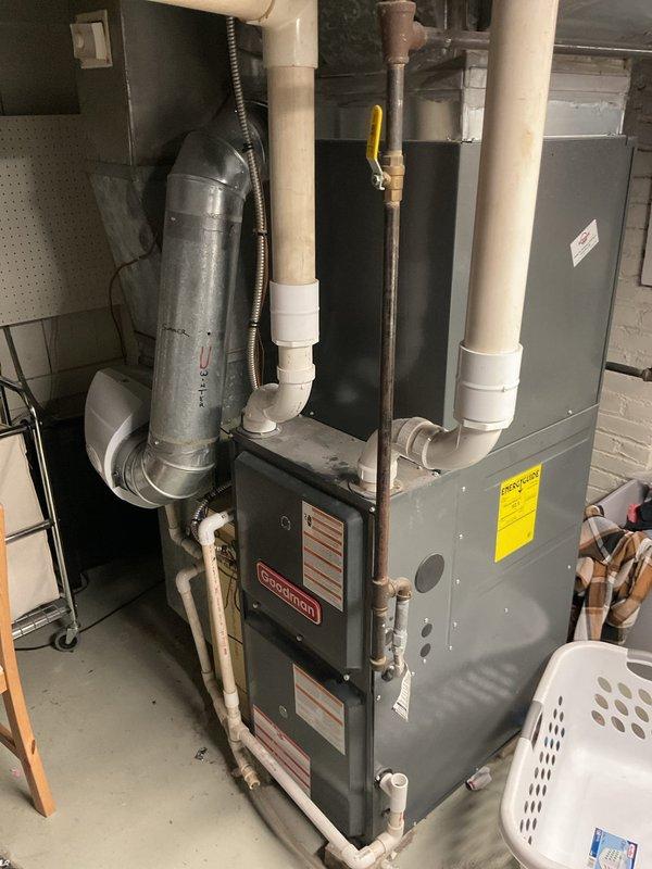 Completed residential HVAC system estimate for complete replacement of existing heating and cooling equipment. Assessed current furnace installation in basement utility area and outdoor air conditioning condenser unit, documenting existing gas line connections, electrical disconnect, PVC venting configuration, and ductwork arrangement for proper equipment sizing and replacement planning.