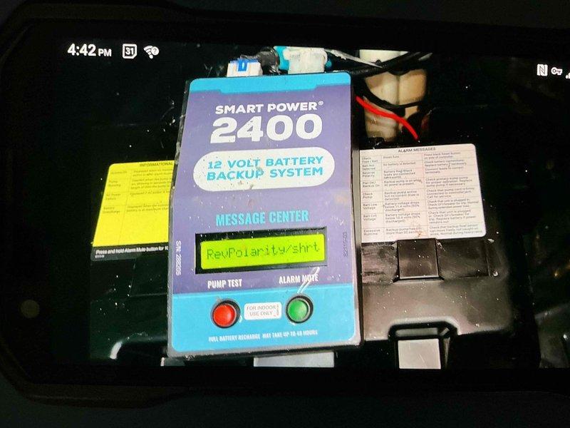 Responded to service call for furnace producing continuous humming sound. Upon inspection, identified issue with 12-volt battery backup system displaying "RevPolarity+Shrt" error code, indicating reverse polarity and short circuit condition. Inspected electrical connections, corrected wiring polarity issue, and verified proper system operation. Tested backup system functionality and confirmed humming noise was eliminated. System restored to normal operation.