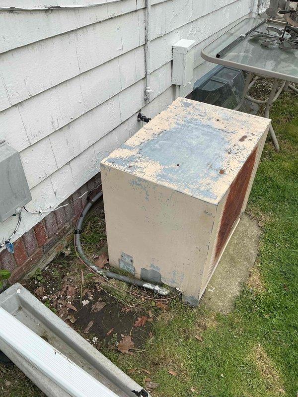 Responded to no cooling complaint on 30-year-old air conditioning unit. Upon arrival, found outdoor condensing unit with severe weathering, extensive rust damage, and corroded electrical components. Customer reported clicking sound prior to shutdown and stated unit had been operated without proper fuse protection. Inspection revealed deteriorated wiring connections with exposed conductors in electrical junction box, significant corrosion throughout contactor housing, and accumulated debris restricting airflow around base of unit. Due to age of equipment, extent of electrical degradation, and safety concerns from compromised wiring, recommended system replacement rather than repair. Unit deemed unsafe for continued operation and advised customer to discontinue use until replacement could be scheduled.