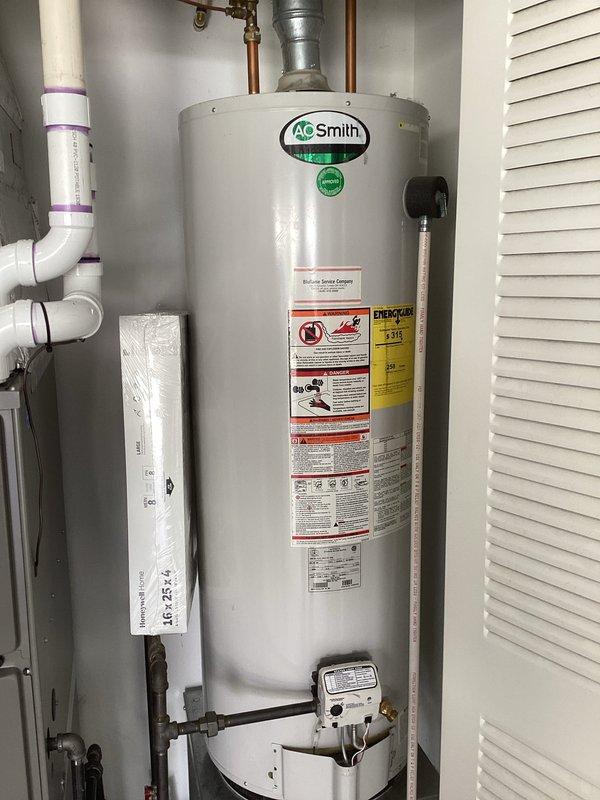 Responded to post-installation callback after city inspector reported gas odor at residence with recently installed natural gas furnace. Performed comprehensive gas leak inspection of furnace installation and surrounding gas appliances including water heater. Conducted pressure testing on all gas connections, checked furnace gas valve, supply piping, and flex connector joints. Inspected water heater gas connections and verified proper venting configuration for both appliances. All connections tested soap-bubble negative for leaks, no gas odor detected upon arrival or during inspection. Confirmed proper installation per code requirements and verified system operation. Documented installation with photos showing compliant furnace and water heater setup with appropriate venting and gas piping.